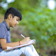 boy outside writing